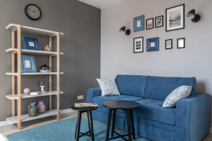 niebieska sofa i dywan w szarym salonie