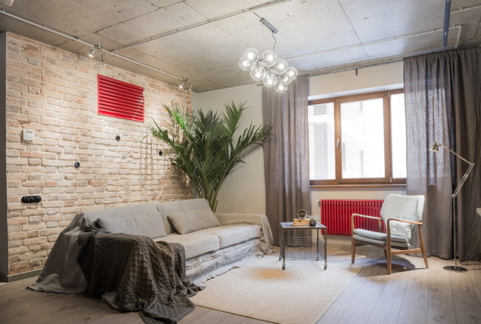 Szary salon i czerwone detale